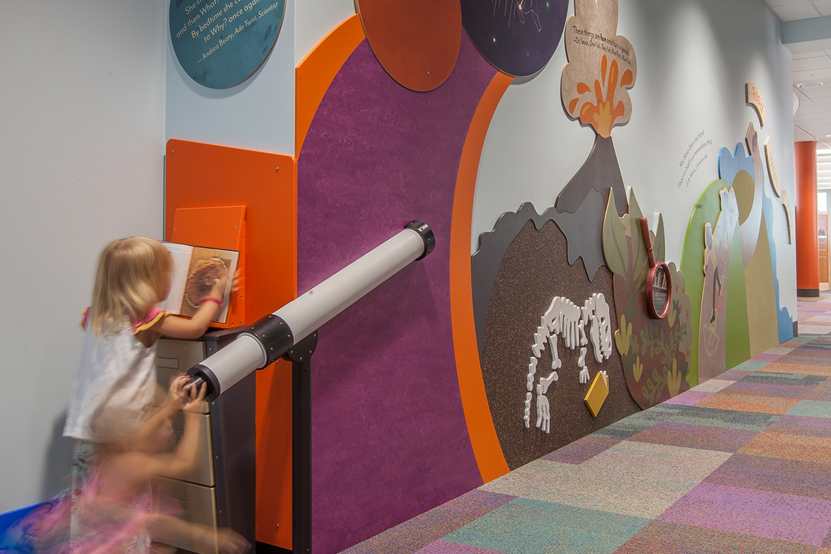 children playing with a giant magnifying glass